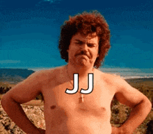 a shirtless man with a mustache is standing in a field with his hands on his hips and the word jj on his chest .