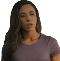 a woman with long hair is wearing a purple top