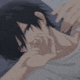 a close up of a person laying on a bed with their hands on their face