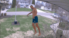 a man without a shirt is jumping in the air with a blink logo in the corner