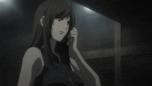 a woman in a black tank top is talking on a cell phone