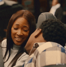 a man and woman are sitting next to each other on a plane and smiling .