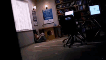 a woman is sitting on the floor in a room with a sign that says " are you ready to improve your life ? "