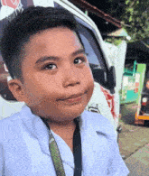 a young boy with a lanyard around his neck that says ' make a wish ' on it