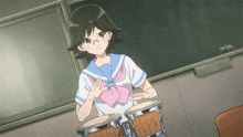 a girl in a sailor uniform is playing drums