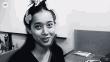 a black and white photo of a woman with a flower in her hair and the word fever on the bottom