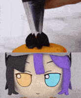 a stuffed animal with purple hair is being decorated
