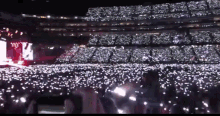 a crowd of people in a stadium with a sign that says u on it