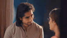 a man and a woman are standing next to each other on the floor .