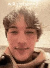 a close up of a young man 's face with the words `` will stetson < 3 '' written above him .