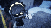 a robot with a black helmet and yellow lights on it