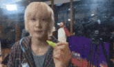 a man in a plaid shirt is holding a yellow marker in front of a camera that says jool on it