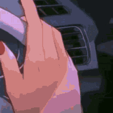 a close up of a person 's hand with a purple nail polish