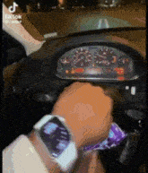 a tik tok video of a person driving a car with a watch on
