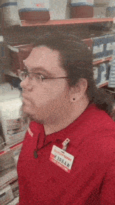 a man in a red shirt with a name tag that says izbwaw