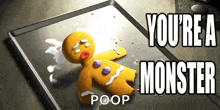 a gingerbread man is laying on a tray with the words " you 're a monster poop " below it