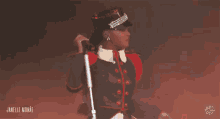 a woman in a military uniform is singing into a microphone and the name janelle monae is on the bottom