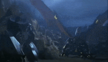 a dragon is flying over a rocky landscape at night