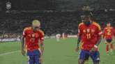 two soccer players are dancing on a field with the number 11 on their jersey