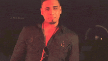 a man in a black shirt is standing in front of a sign that says the maw on it