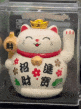 a lucky cat with chinese writing on it
