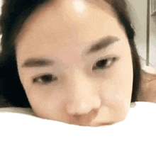 a close up of a woman 's face with her eyes closed .