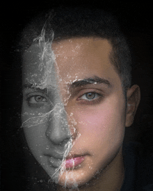 a black and white photo of a man 's face with half of his face covered in water