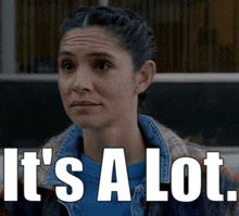 a woman says it 's a lot while wearing a denim jacket