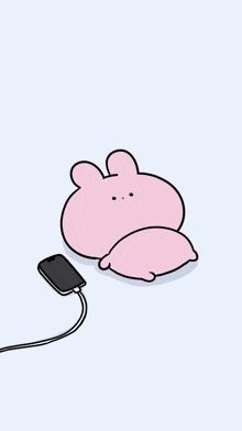 a pink bunny is sitting at a table with a tablet and a book