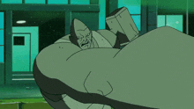 a green cartoon character is holding a hammer in his hand