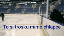 a hockey rink with the words to si trosku mimo chlapce on the bottom