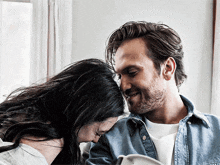 a man and a woman are looking at each other with their eyes closed