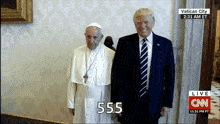 a man in a suit and tie is standing next to a man in a white robe with a cross on it .