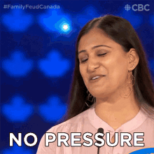 a woman says " no pressure " in front of a microphone