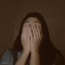 a woman covering her face with her hands and the words cantik banget written below her