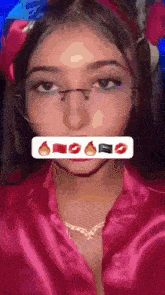 a woman wearing glasses and a pink robe has a sticker on her face that says ' i love you '