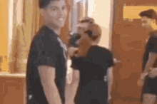 a man in a black shirt is standing next to a woman in a black shirt .
