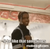 a man is standing in front of a sign that says `` it be like that sometimes `` .