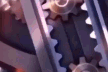 a close up of a metal gear with a purple background