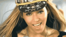 a close up of a woman wearing a hat and a microphone