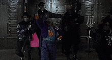 a group of men are standing next to each other in front of a door .