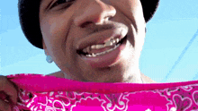 a close up of a man wearing a bandana and earrings