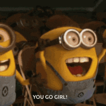 two minions from the movie despicable me are waving their hands and saying you go girl .