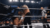 a wrestler in a ring with the word aew on the corner
