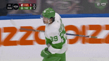a hockey player in a green jersey with the number 39 on it