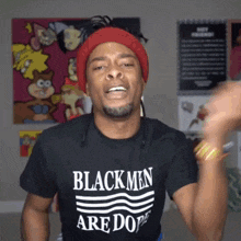 a man wearing a black shirt that says blackmen are dope