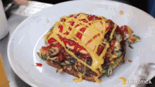 a white plate topped with a sandwich with ketchup and mustard on it