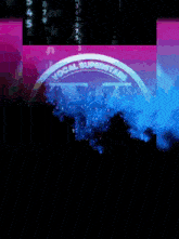 a sign that says vocal superstars on it with a crowd in the background