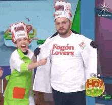 a woman is pointing at a man wearing a fogon lovers t-shirt