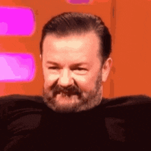 a close up of a man with a beard making a funny face .